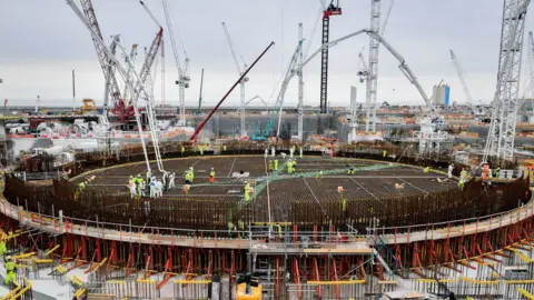 PA Media The base for the first reactor at Hinkley Point C power station being constructed