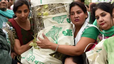 Delhi residents hug a tree