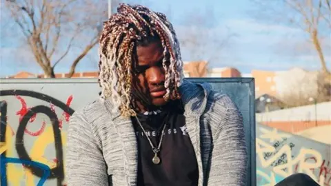 Brinston Tchana Brinston on a modelling shoot outside under blue sky