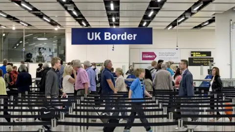 Getty Images Passport checks at the UK border in Gatwick Airport