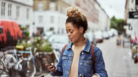 Getty Images A woman on her phone