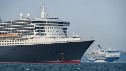 Getty Images Redundant cruise ships moored in Weymouth bay in 2020.