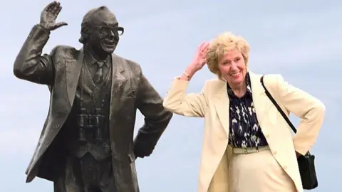 PA Media Joan Morecambe and her husband's statue in Morecambe