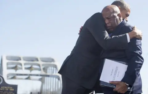 AFP/Getty Images Barack Obama (L) hugs US Representative John Lewis near the Edmund Pettus Bridge in Selma
