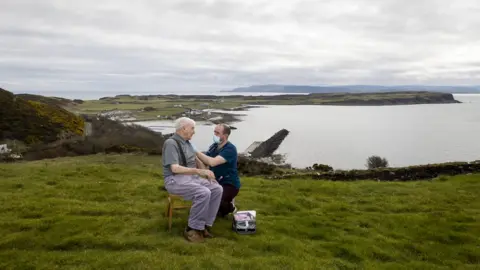 Liam McBurney Dr Gavin Chestnut vaccinating a man on Rathlin Island