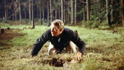 Getty Images Steve McQueen emerges from a tunnel in The Great Escape