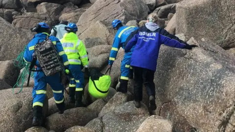 Dan Jarvis / BDMLR Seal being carried in high vis rescue bag