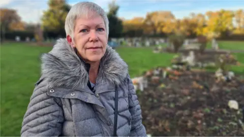 Stuart Woodward / BBC Jane Jefferis standing in Woodside Cemetery in Benfleet