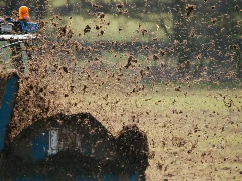 mikedabell/Getty Images Farmer muck spreading