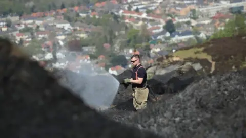 Ronald Grant Firefighters remain on Ilkley Moor on Monday