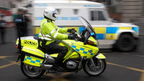 Alamy SNI Police Service Northern Ireland motorcycle officer speeding through belfast
