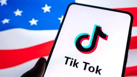 TikTok logo a smartphone screen with a US flag in the background.