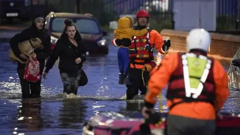 Getty Images Dog and child carried to safety in Doncaster