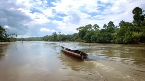 The solar canoe cruising the wide rivers in Achuar territory