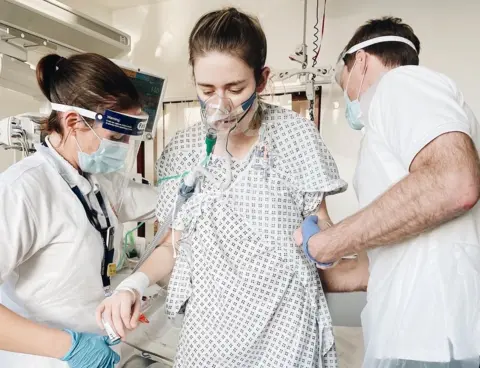 Catherine McCarroll Dr Catherine McCarroll is helped up by medics after her double lung transplant