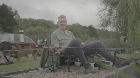NHS Charities Together Nick Buck sitting in a chair fishing
