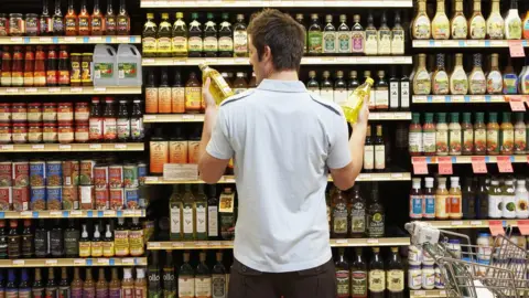 Getty Images Man decides between two items