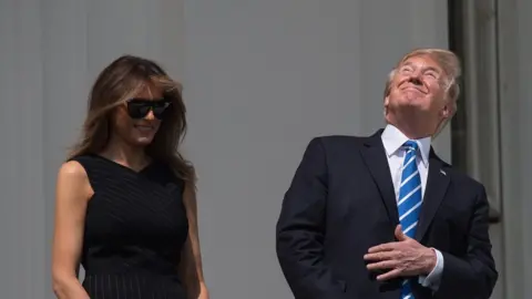 AFP US President Donald Trump, with First Lady Melania Trump at his side, looks up at the partial solar eclipse from the balcony of the White House in Washington, DC, on August 21, 2017