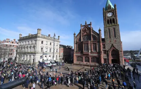 PA Outside the Guildhall crowds of people gathered to show their support for victims' families.