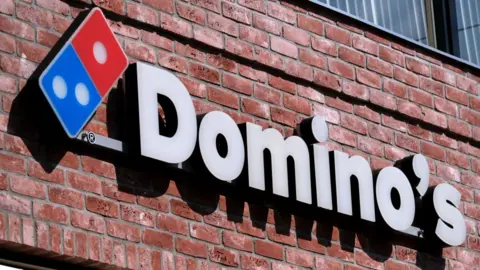 Getty Images A sign that reads: Domino's