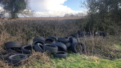 Tim Papworth Fly-tipped tyres, north Norfolk