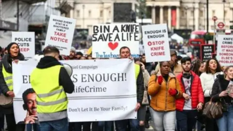 BBC Protesters carrying anti-knife crime placards