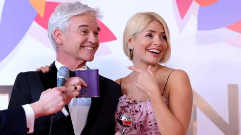 Getty Images Holly Willoughby and Phillip Schofield pose with the Daytime Award in the winners room during the National Television Awards held at The O2 Arena on January 22, 2019 in London, England