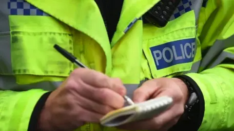 Police officer writing notes