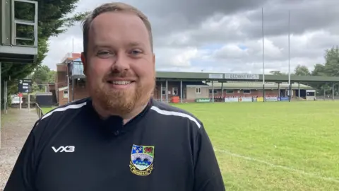 Will Rees standing by the pitch at Bedwas RFC