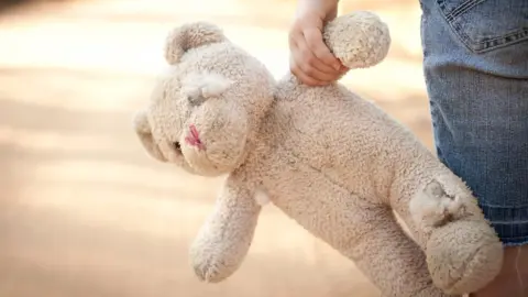 Getty Images A generic image of a child holding a soft toy