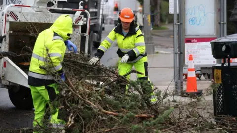 Getty Images Crews clearing fallen trees