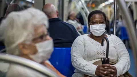 Getty Images People wear protective mask on the subway on February 27, 2020 in São Paulo, Brazil.