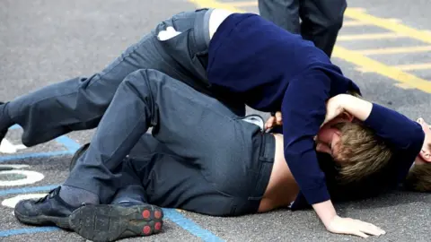 Getty Images Two schoolboys fighting