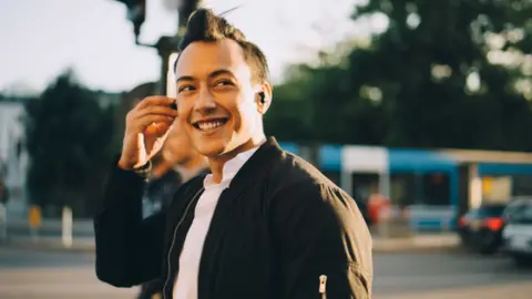 Getty Images A young man wearing in-ear headphones