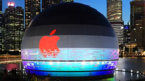 Getty Images Apple flagship store against the city skyline at Marina Bay Sands waterfront.