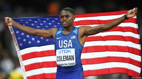Getty Images This is a photo of athlete Christian Coleman holding up the American flag.