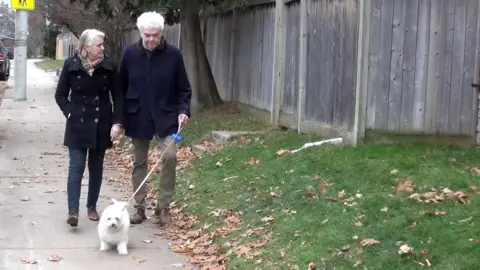 Sunnybrook Hospital  Frank Plummer, seen with his wife Jo walking their dog