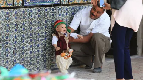 AFP Tunisian families bring their children for annual circumcision feast tradition at Sidi Sahab Zawiya and Madrasa ahead of Laylat al-Qadr in Kairouan, Tunisia on June 11, 2018