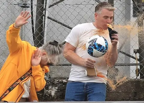 Colin Johnstone/QOTS Fan spilling drink