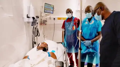 Reuters Lagos Governor Babajide Sanwo-Olu (R) visiting some of the injured in hospital - 21 October 2020