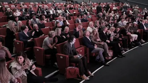 PA Media People seated at a business conference