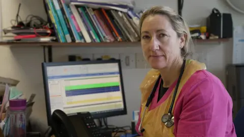 Dr Rachel Warrington at her desk