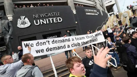 Newcastle fans celebrate the club's recent takeover