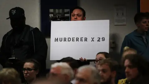 Getty Images protester holds sign accusing Blankenship of murder