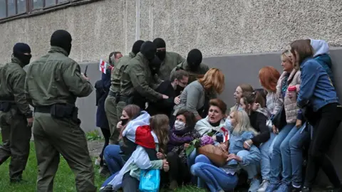 Getty Images Women are detained during a march in support of Maria Kolesnikova and other opposition leaders