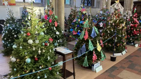Luke Deal/BBC Christmas trees on display at Sudbury Arts Centre