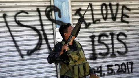 EPA A Filipino government troop conducts patrol on a reclaimed former Maute stronghold in Marawi City, Mindanao Island, southern Philippines, 30 May 2017, as fighting between Islamist militants and government forces continues