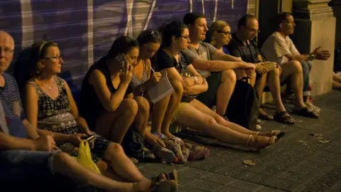 Reuters People wait to enter the area after a van crashed into pedestrians near the Las Ramblas avenue in central Barcelona, Spain August 17, 2017