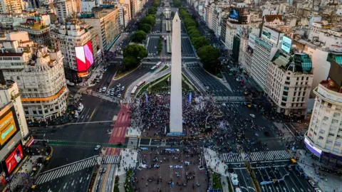 Getty Images Fans gather around the Obelisk of Buenos Aires to cheer and pay tribute