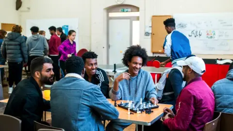 The Harbour Project Refugees sat around a table